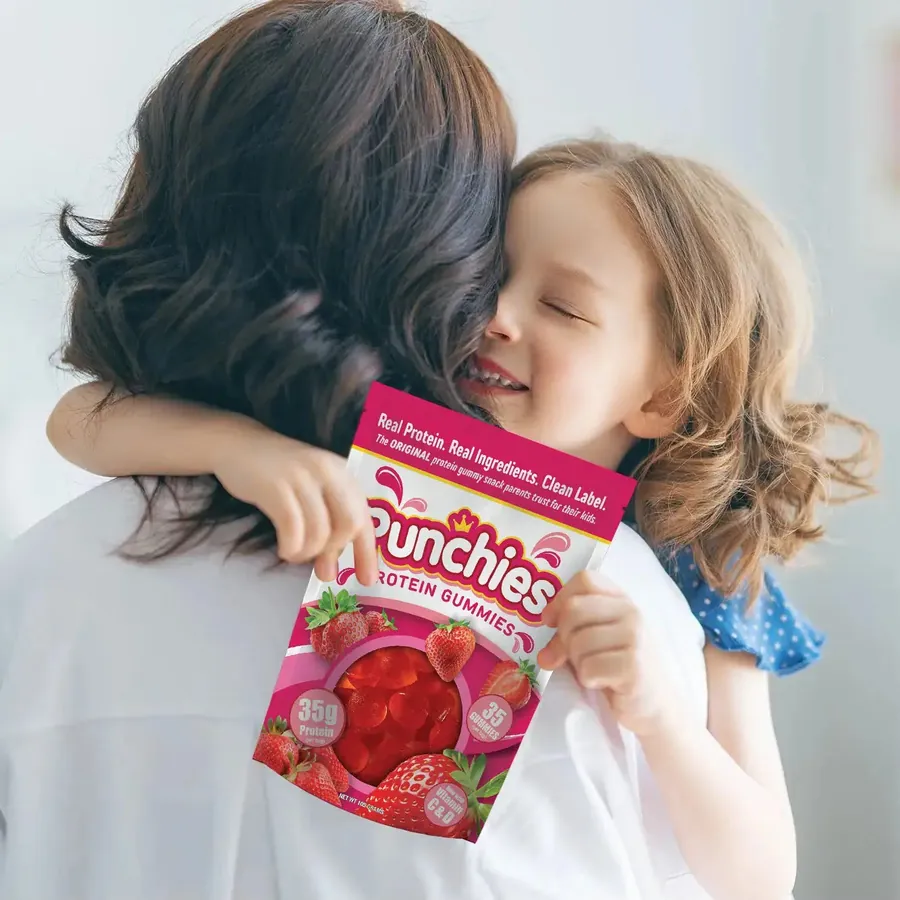 Kids protein powder: a parent hugging a child with a bag of Punchies protein gummies